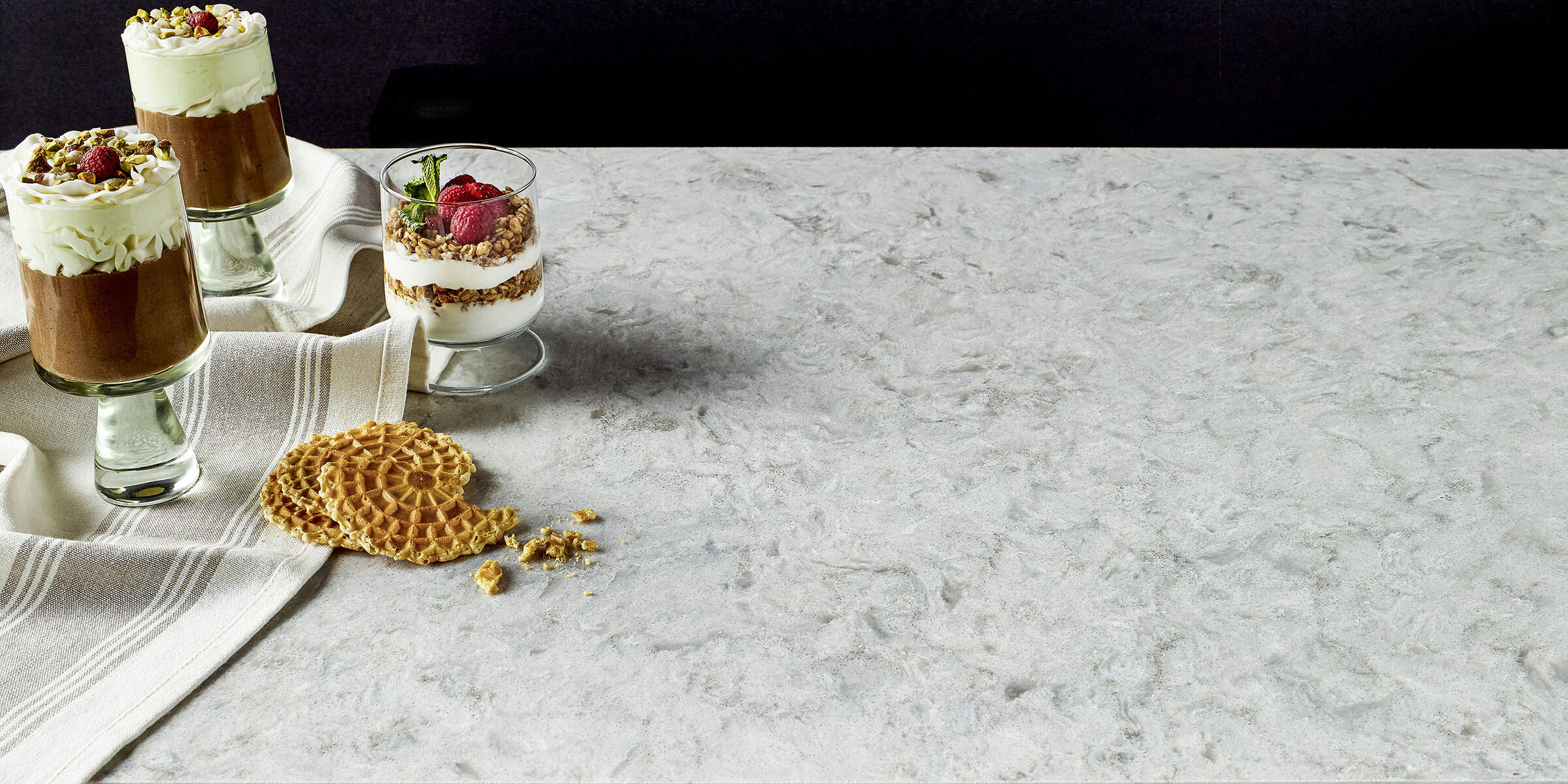 Soft gray quartz countertops in a warm kitchen