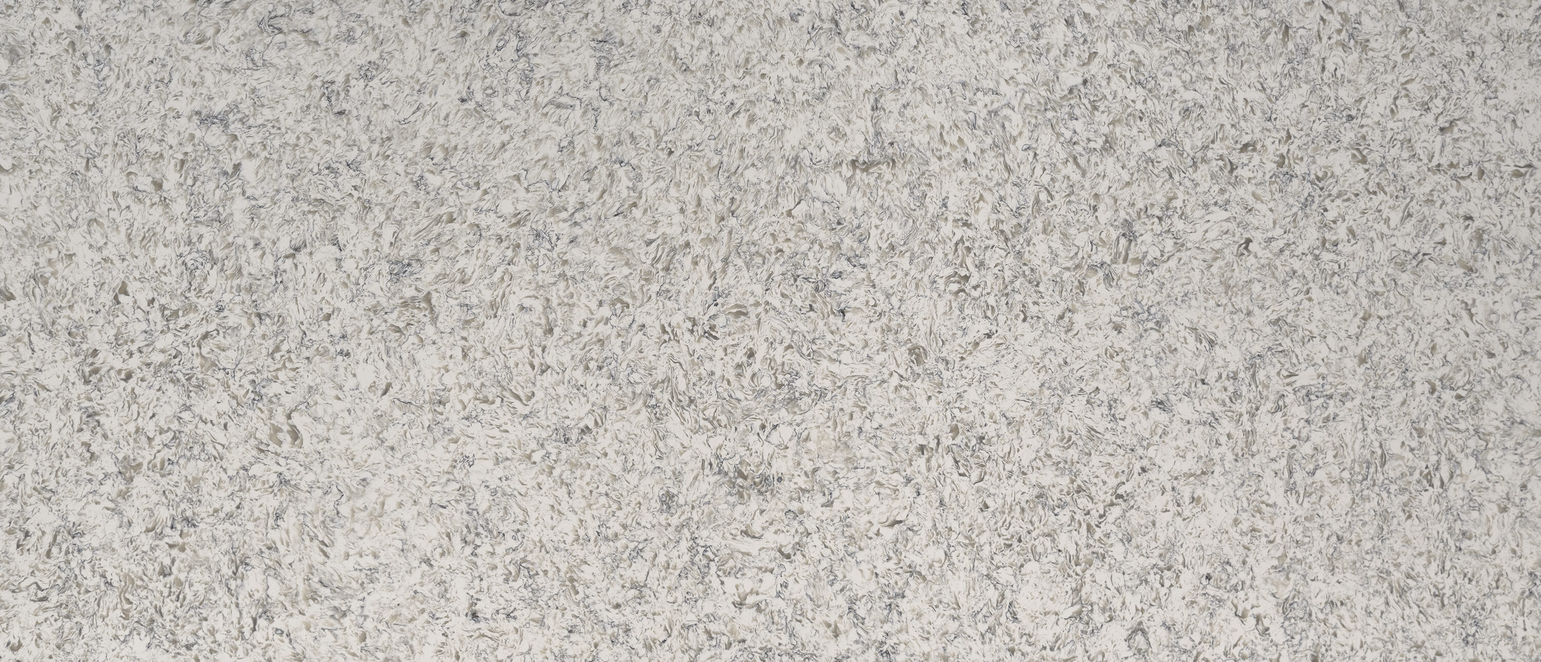 Crisp white quartz countertops in a bright suburban kitchen