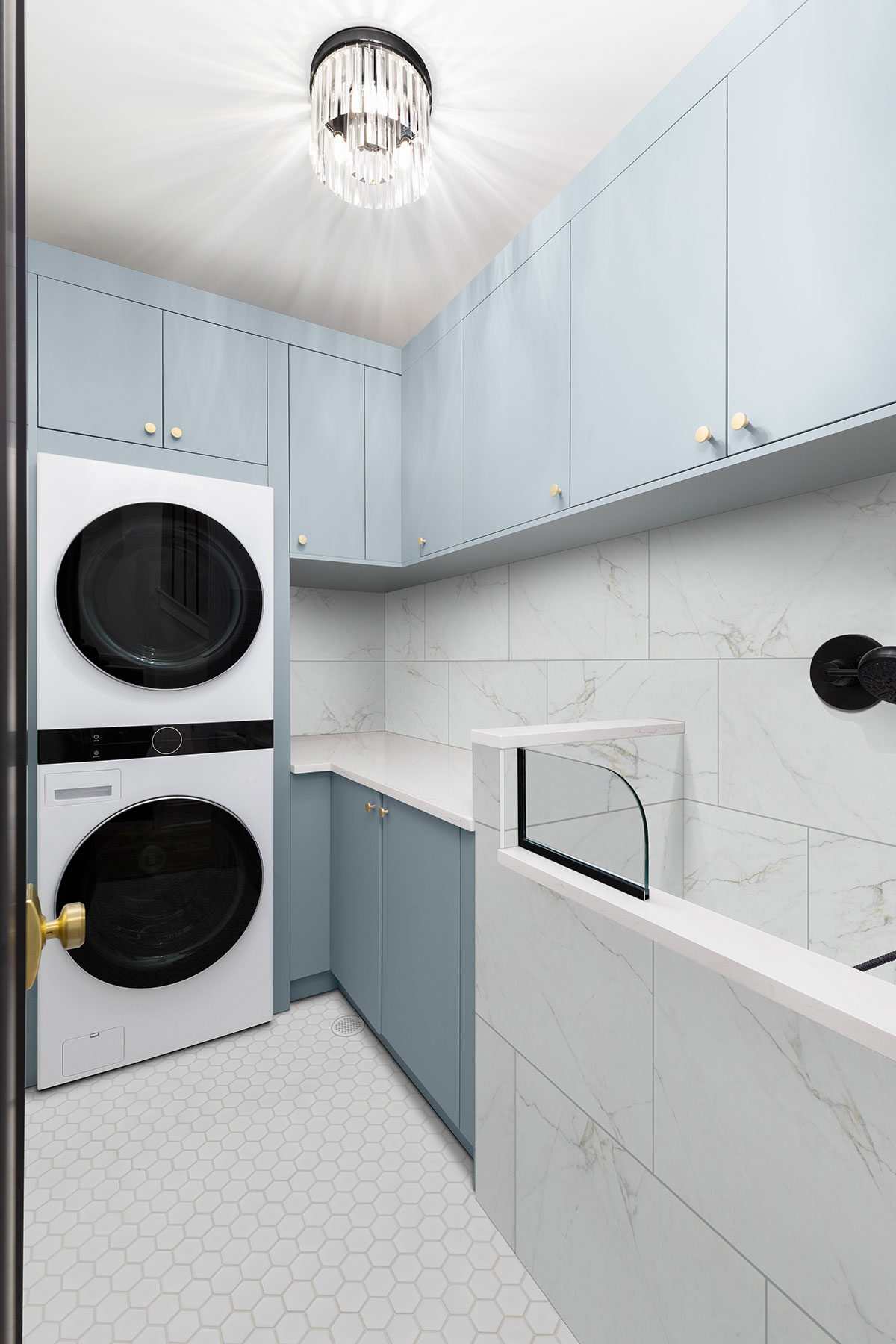 White Glossy 2” Hexagon Mosaic Tile backsplash in a laundry room