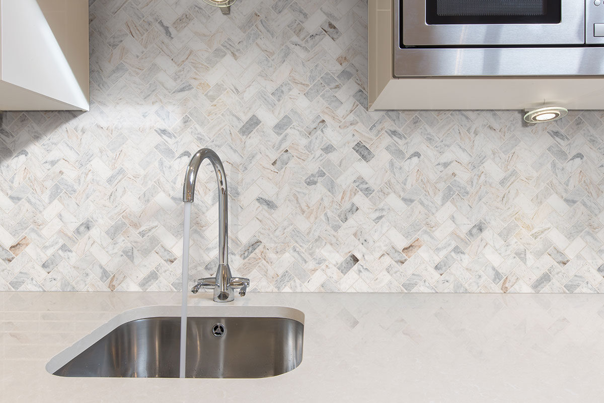 Capri Blue 1x2 Herringbone Honed Subway Tile backsplash installed — view 3