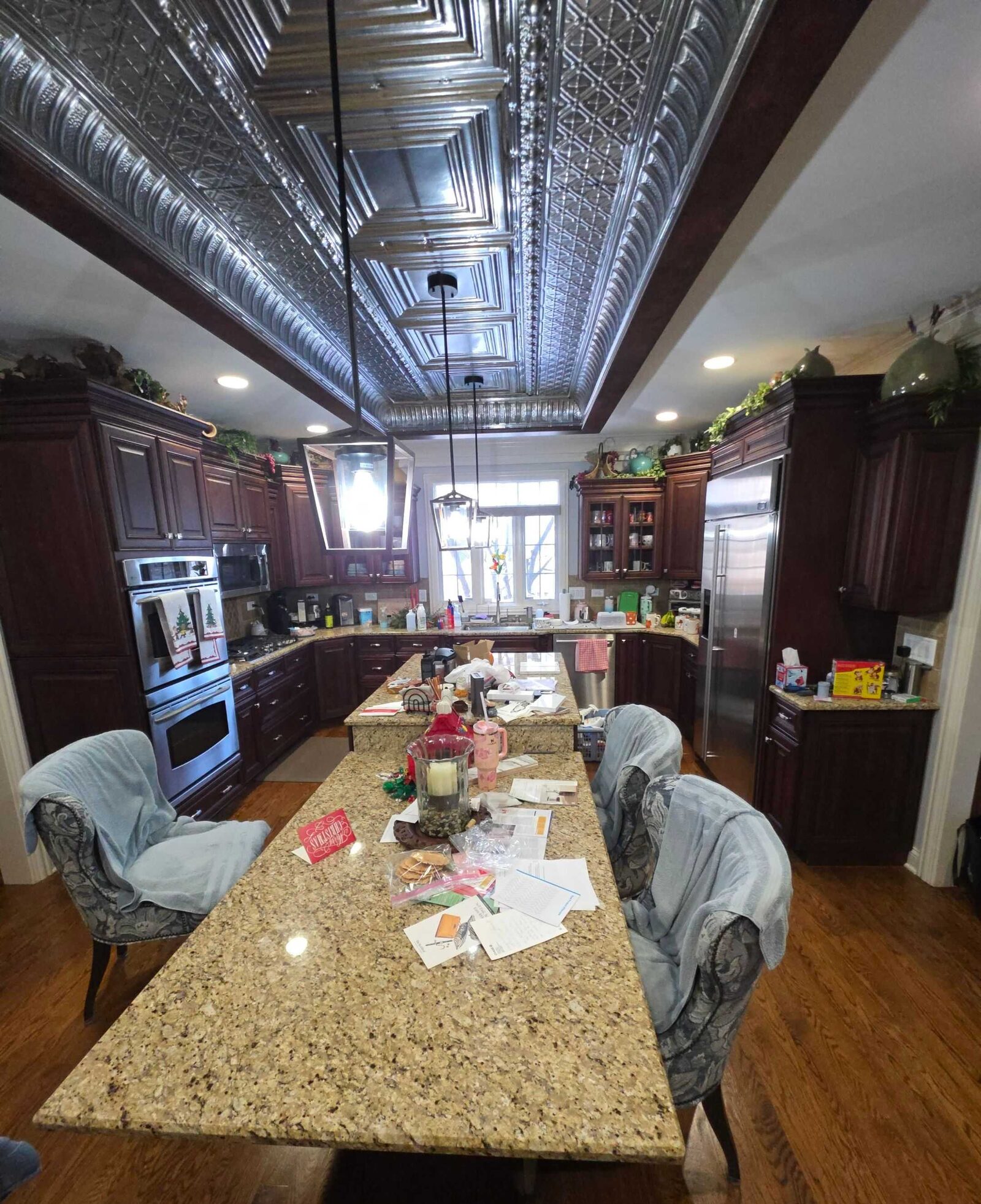 The same dining-room table before the work, topped in mottled beige granite