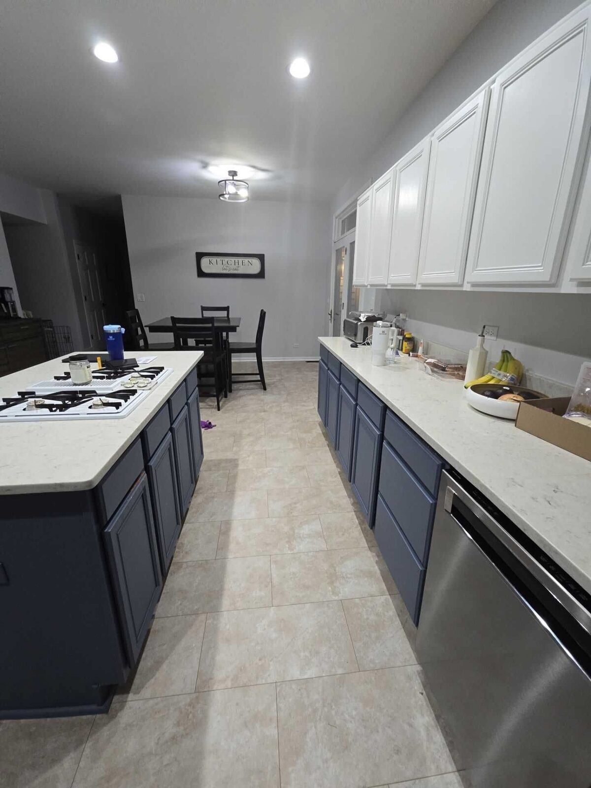 The kitchen from the stair end, quartz island with a cooktop set into it