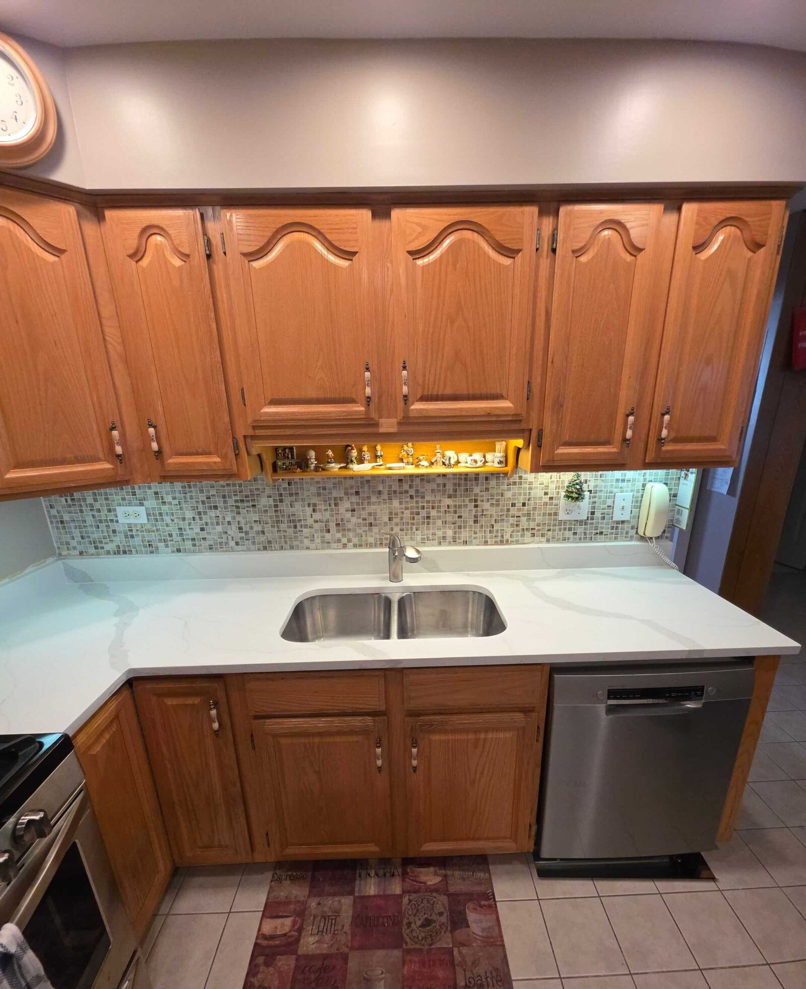 The finished sink run seen from the range end, dishwasher to the right