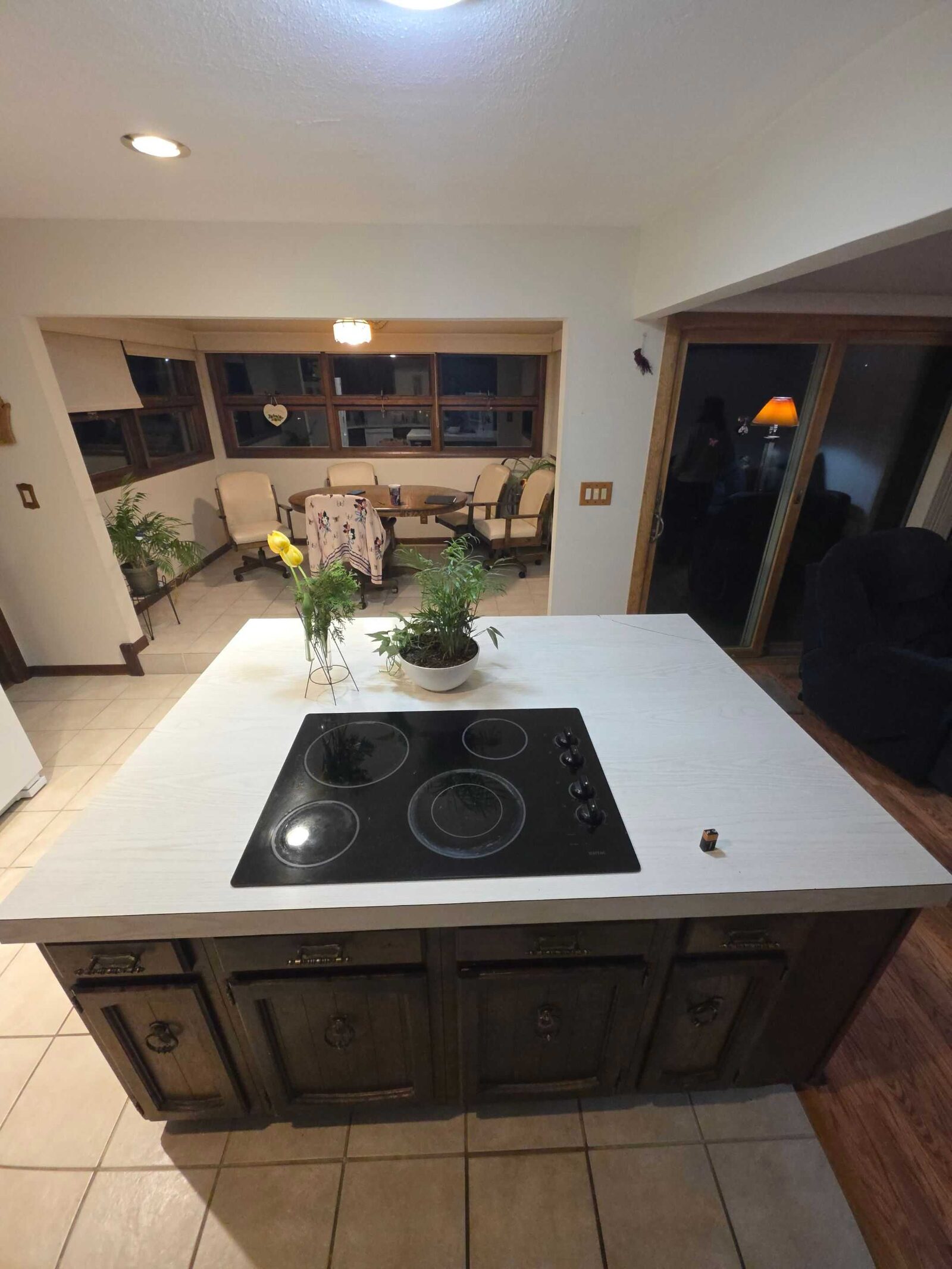 Before: the island cooktop and the doorway through to the dining room