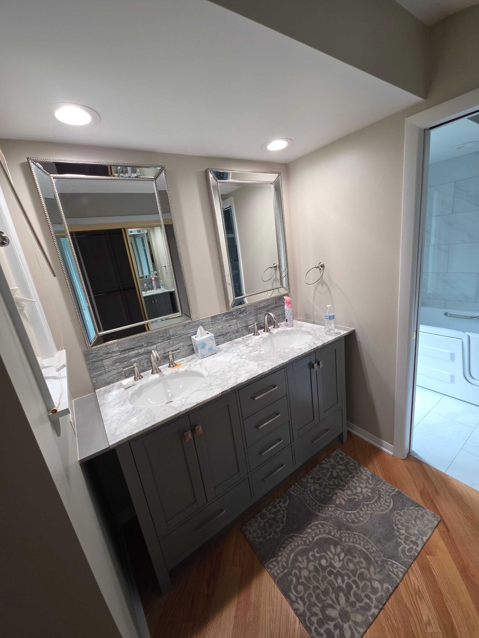 The finished bathroom vanity from the doorway, quartz top and matte black taps