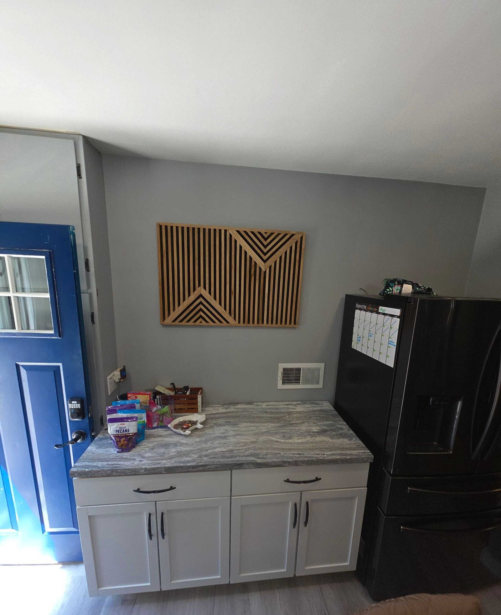 Before: the gray laminate run beside the blue back door and the black refrigerator