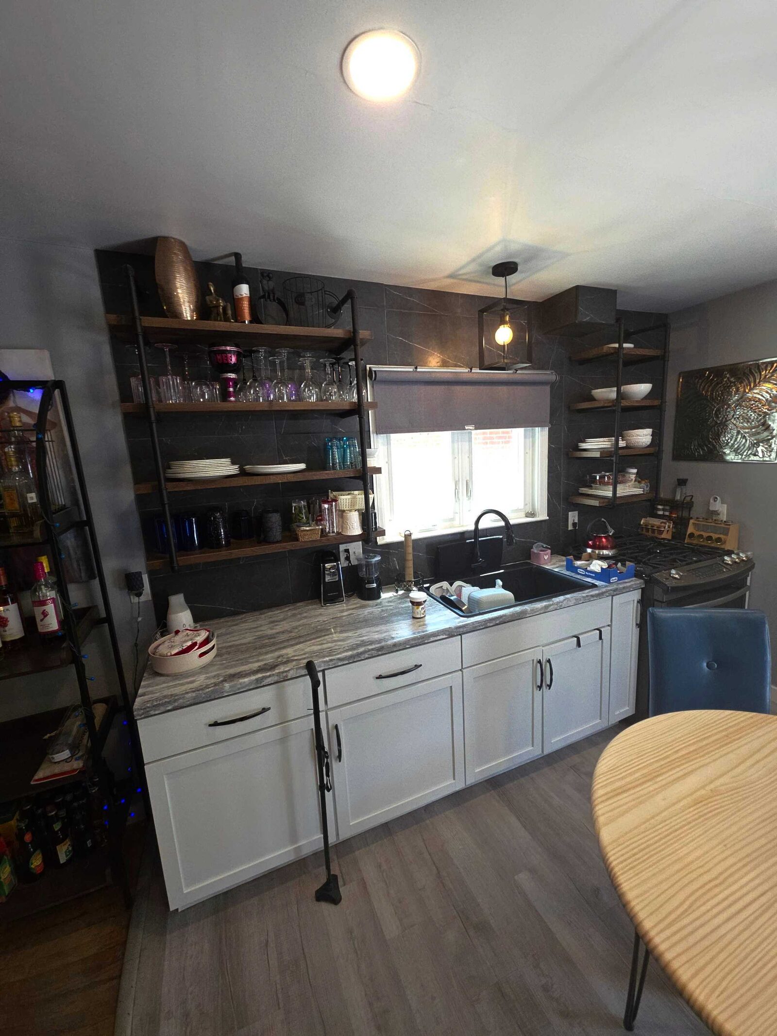 The same run before, topped in a gray marbled laminate that matched neither the cabinets nor the hardware